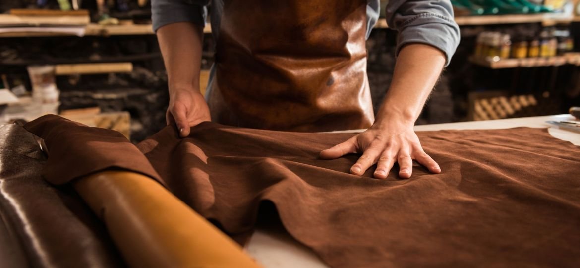 Close up of a cobbler working with leather textile