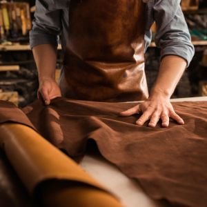 Close up of a cobbler working with leather textile